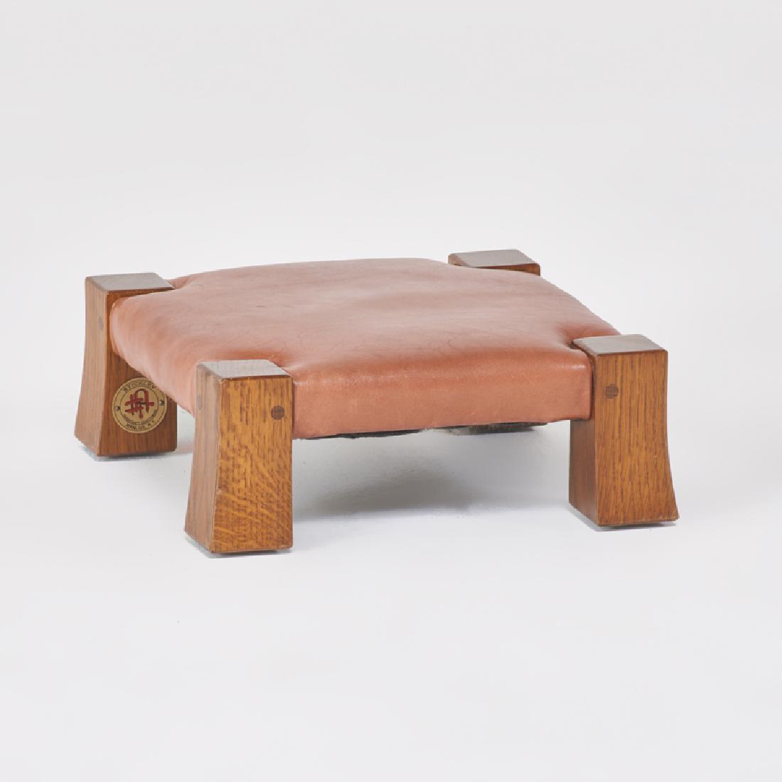 STICKLEY; E.J. AUDI: Contemporary gout stool in the style of Gustav Stickley, Manlius, NY, 2000s Quartersawn oak, leather Metal tag 4 3/4" x 12 1/2" sq.
