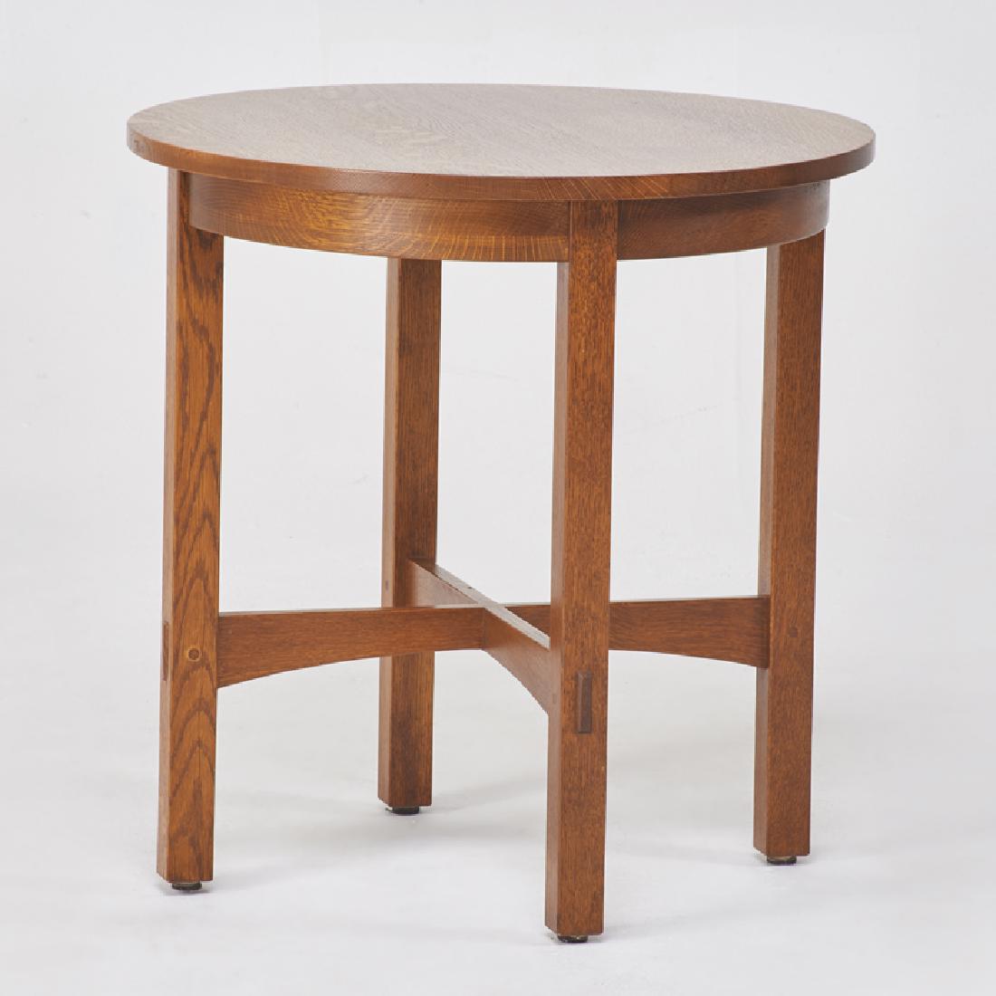 STICKLEY; E.J. AUDI: Contemporary circular lamp table with arched cross-stretchers, in the style of L. & J.G. Stickley, Manlius, NY, 1991 Quartersawn oak Metal tag, branded mark 26 1/4" x 25 3/4" dia.
