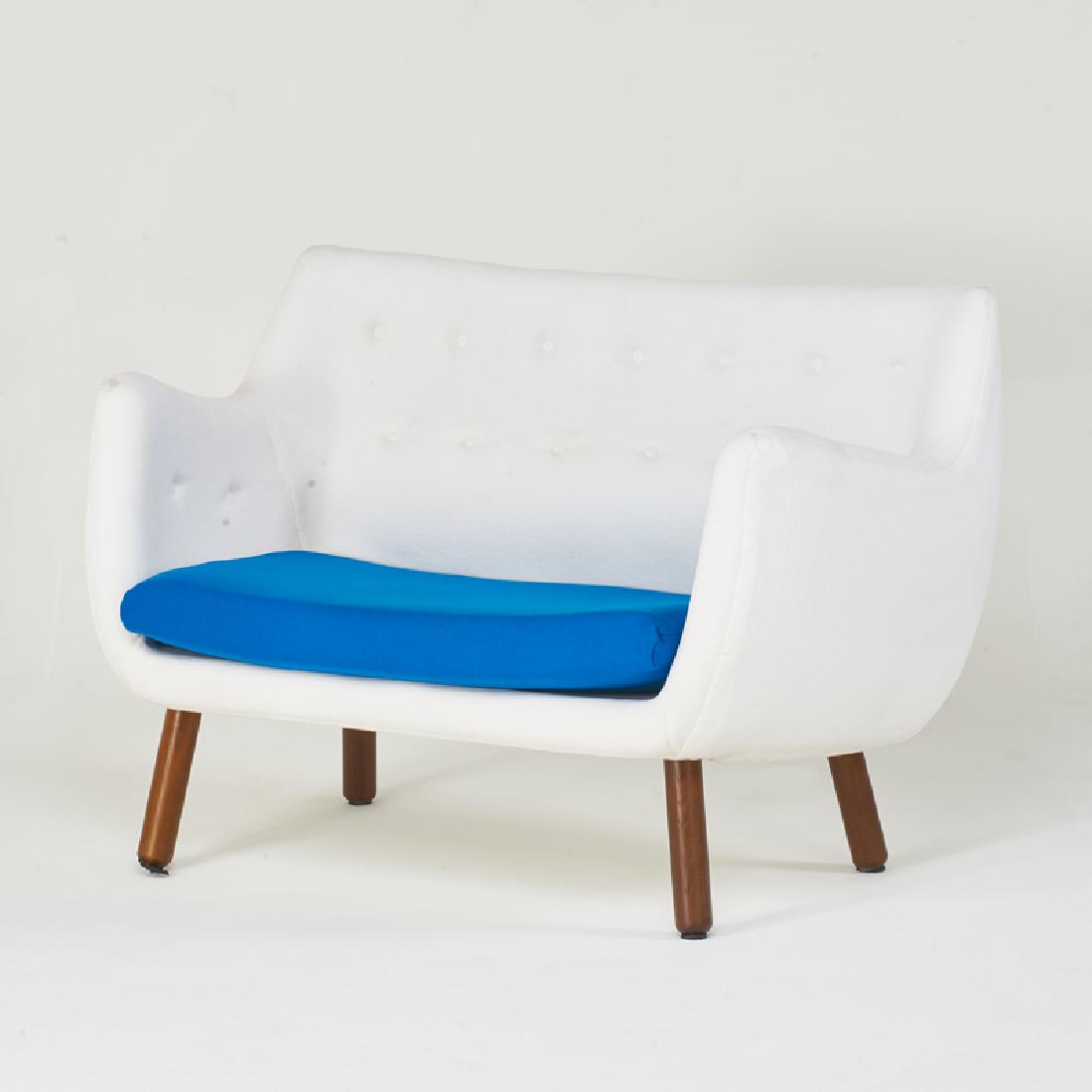 STYLE OF FINN JUHL: Loveseat, 2000s Turned and stained wood, upholstery Unmarked 36" x 52" x 32"