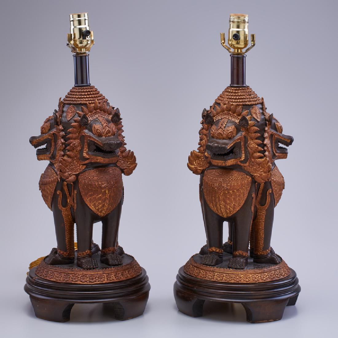 FREDERICK COOPER: Pair of sculptural table lamps depicting three-sided foo dogs, Chicago, 20th c. Patinated and painted metal, wood base One labeled 19 1/2" x 8 1/2" dia.