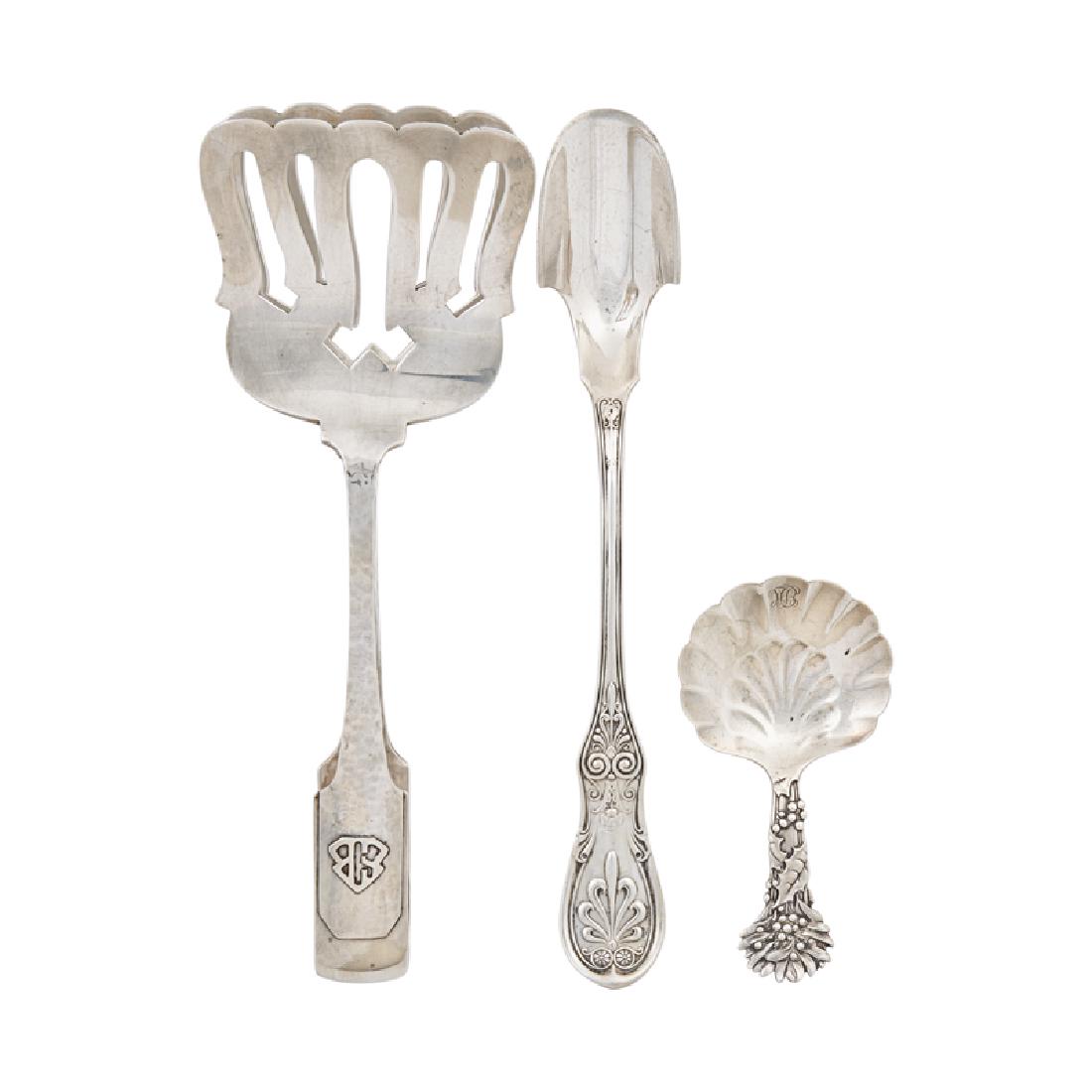 STERLING SILVER SERVING PIECES: Three: Tiffany & Co. Holly pattern bon-bon spoon (1891-1902), Tiffany & Co. Saratoga cheese scoop (1907-47), and a Shreve & Co. San Francisco, Norman Hammered asparagus server (1909), USA; Marked; 10.