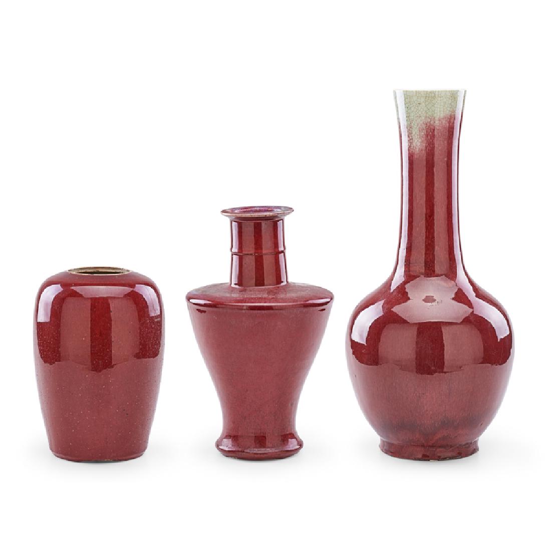 THREE CHINESE SANG DE BEOUF PORCELAIN VASES: Each a different form, China, 19th/20th c.; Largest: 22" x 9" dia.