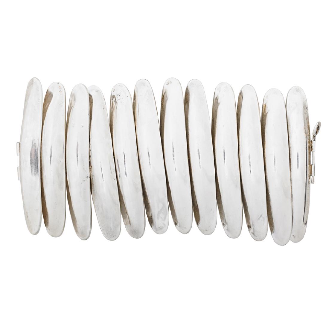 ROBERT LEE MORRIS SILVER BRACELET: A concentric design of concave oblong panels. Signed by the maker. 8". 340.2 gs.