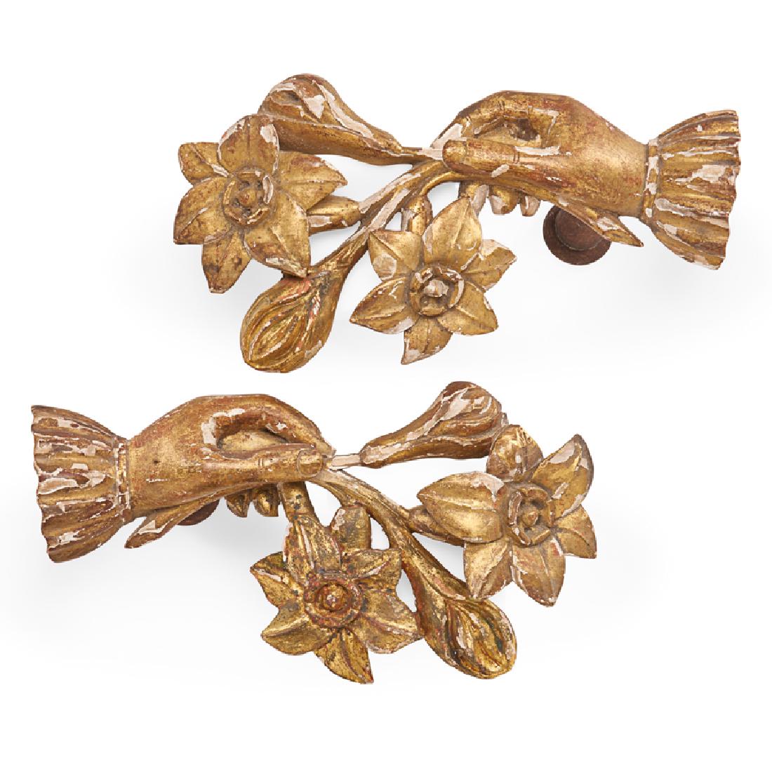 PAIR OF CARVED AND GILDED TIE-BACKS: Each in the form of a hand holding a posy, gilded wood, Continental, 19th c. 9 1/2" x 5" x 5"