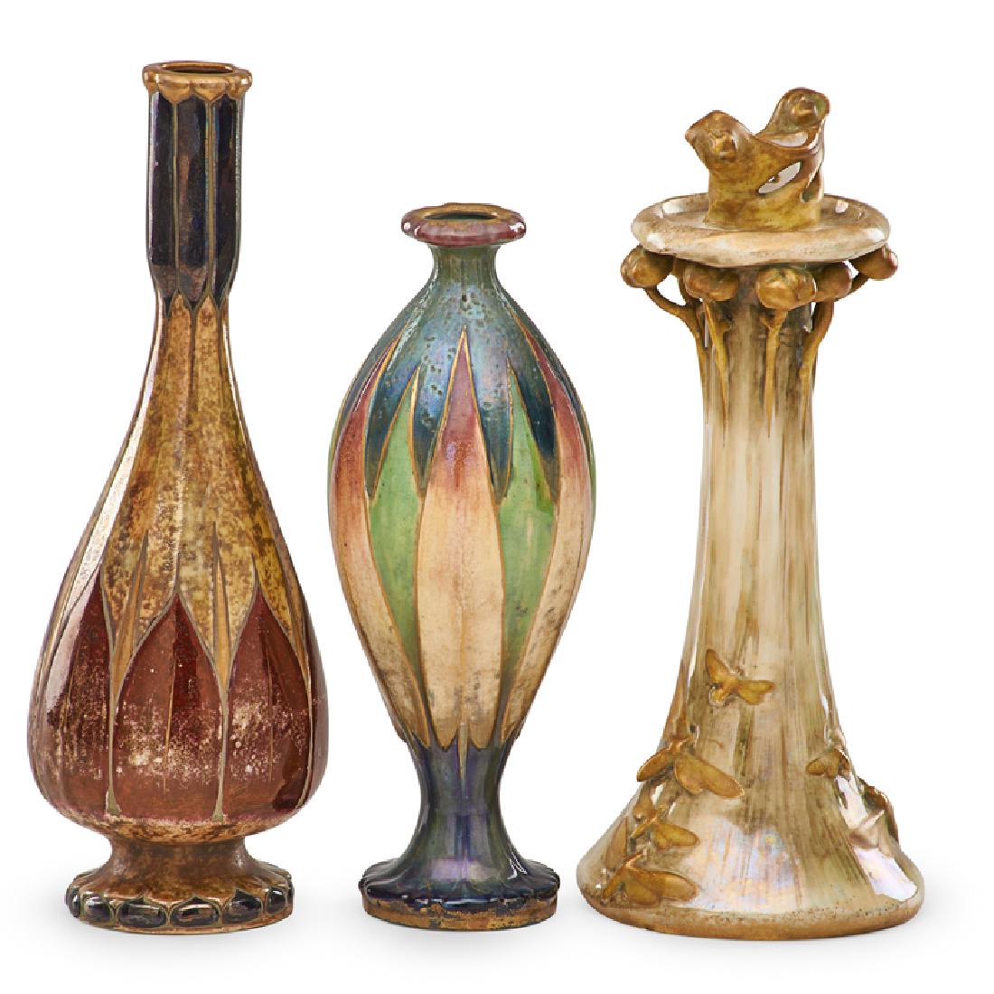 RSTK Two Amphora vases, candlestick: EDUARD STELLMACHER (1868 - 1945) RIESSNER, STELLMACHER & KESSEL Amphora "Magic of Fire Light" candleholder from the Fates series by Stellmacher and two Amphora stylized floral vases, Turn-Teplitz, Boh