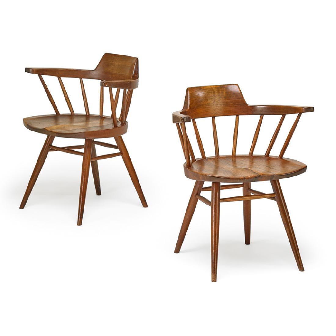 GEORGE NAKASHIMA Pair of Captain's chairs: GEORGE NAKASHIMA (1905 - 1990) NAKASHIMA STUDIO Pair of Captain's chairs, New Hope, PA, 1970 or 71 Walnut, hickory Each signed with client name 20 1/2" x 24" x 20 1/2" Provenance: Copies of original o