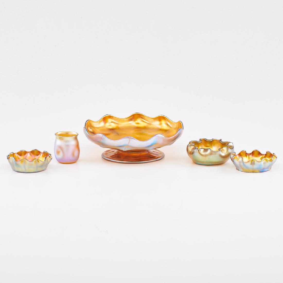 TIFFANY STUDIOS: Five gold Favrile pieces: three salts and footed bowl with ruffled rims, and dimpled cabinet vase, New York, early 20th c. Blown glass All signed Largest: 2" x 6 1/8" dia.