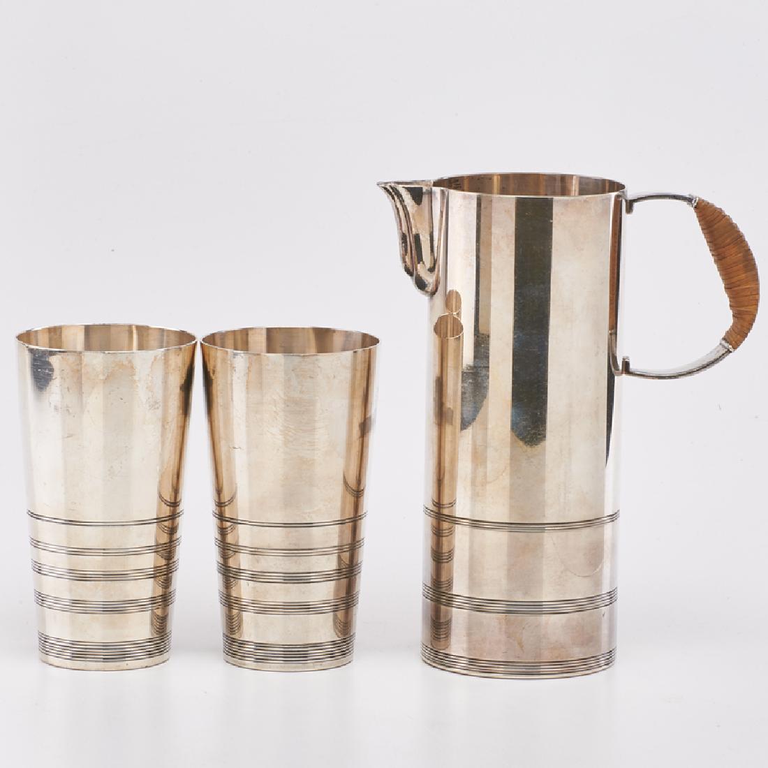 LURELLE GUILD (1898-1985); INTERNATIONAL GIFT WARE: Three-piece lemonade set: pitcher and two tumblers, Meriden, CT, ca. 1935 Silver plate, wicker handle All marked Pitcher: 9" x 7"