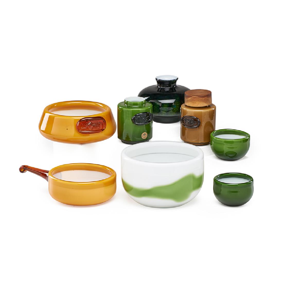 HOLMEGAARD KASTRUP: Eight pieces: three bowls, dog bowl, vase, handled pot, and two jars, Denmark, ca. 1960s Glass Most unmarked, one with original paper label Largest: 4 1/2" x 7 1/4" dia.