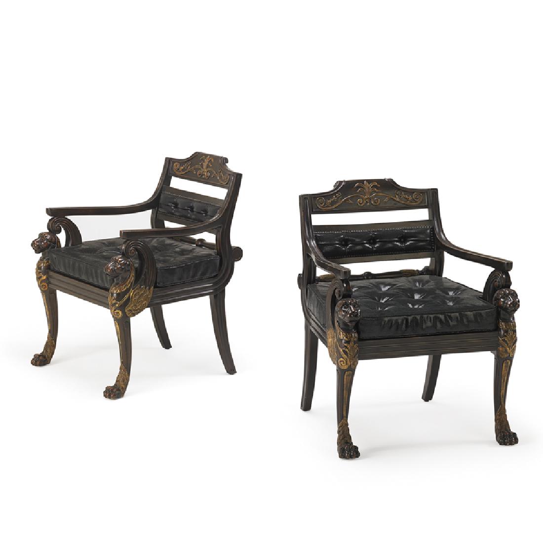THEODORE ALEXANDER: Pair of library armchairs with carved griffin arm supports and paw feet, 2000s Stained, and parcel gilt wood, wicker seats, printed upholstery, patinated tacks Stamped numbers to frame 36" x 27" x 27"
