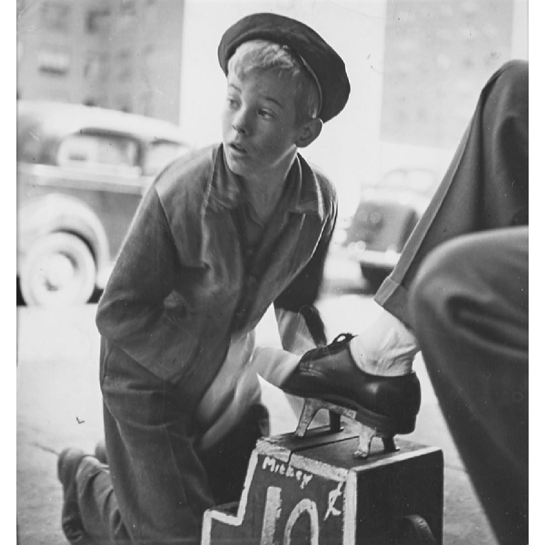Stanley Kubrick (American, 1928-1999): Mickey, The Shoeshine Boy, 1947 Ferrotyped photograph (framed) Look and Modern Photography magazine stamps with reduction notations in pencil and crayon to verso 8 1/2" x 8" (sight) Literature: A Tale
