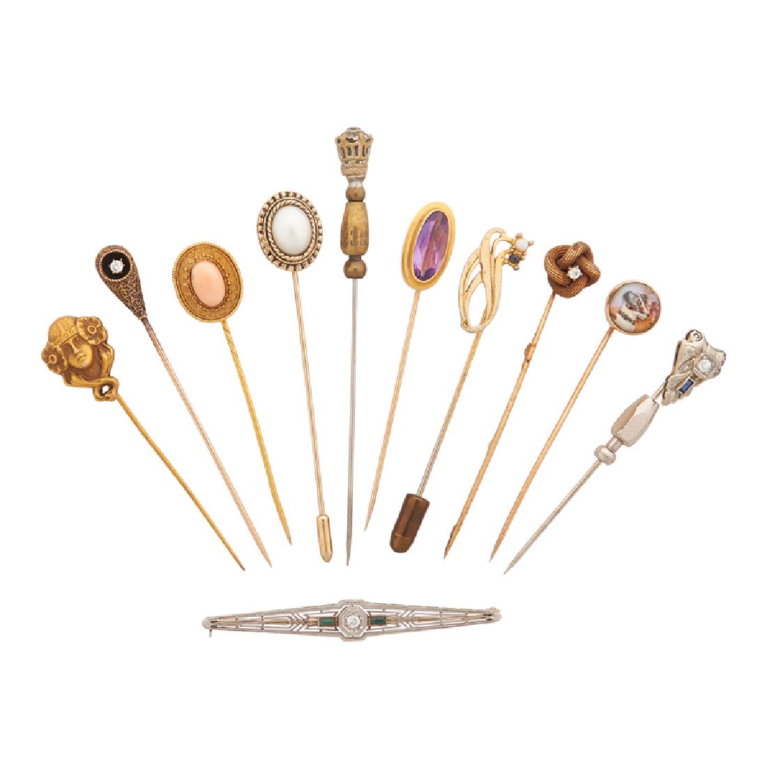 EARLY 20TH C. STICKPINS OR BAR BROOCH: Comprising seven yellow or white gold stickpins, including an oval angel skin coral cabochon in roped 14k yellow gold and a reverse carved and painted crystal intaglio depicting a Jack Russell in 10k;