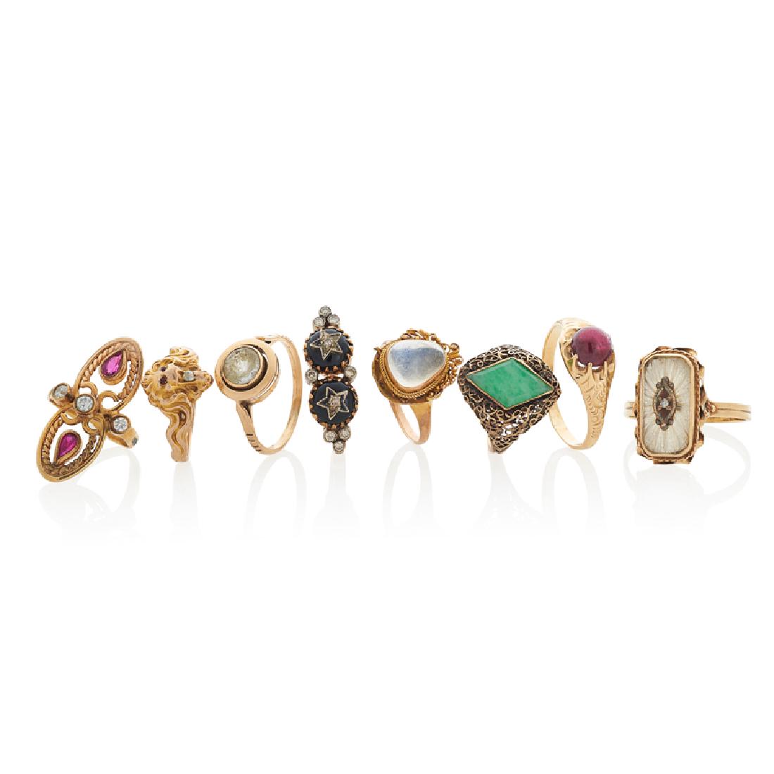EARLY 20TH C. GEM-SET YELLOW GOLD OR GOLD-FILLED RINGS: The seven gold and one gold-filled rings with diamonds, carved rock crystal, tourmaline, jade, moonstone, garnet, onyx, paste or glass. 14.2 dwt.