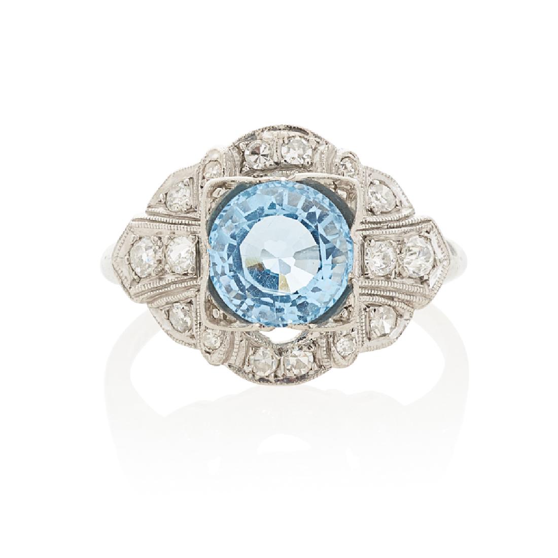 EDWARDIAN TOPAZ, DIAMOND & PLATINUM RING: The round-faceted topaz centered by OMC diamonds in millegrained platinum, approx. .28 ct. TW. Ca. 1905. Size 6. 2.2 dwt.