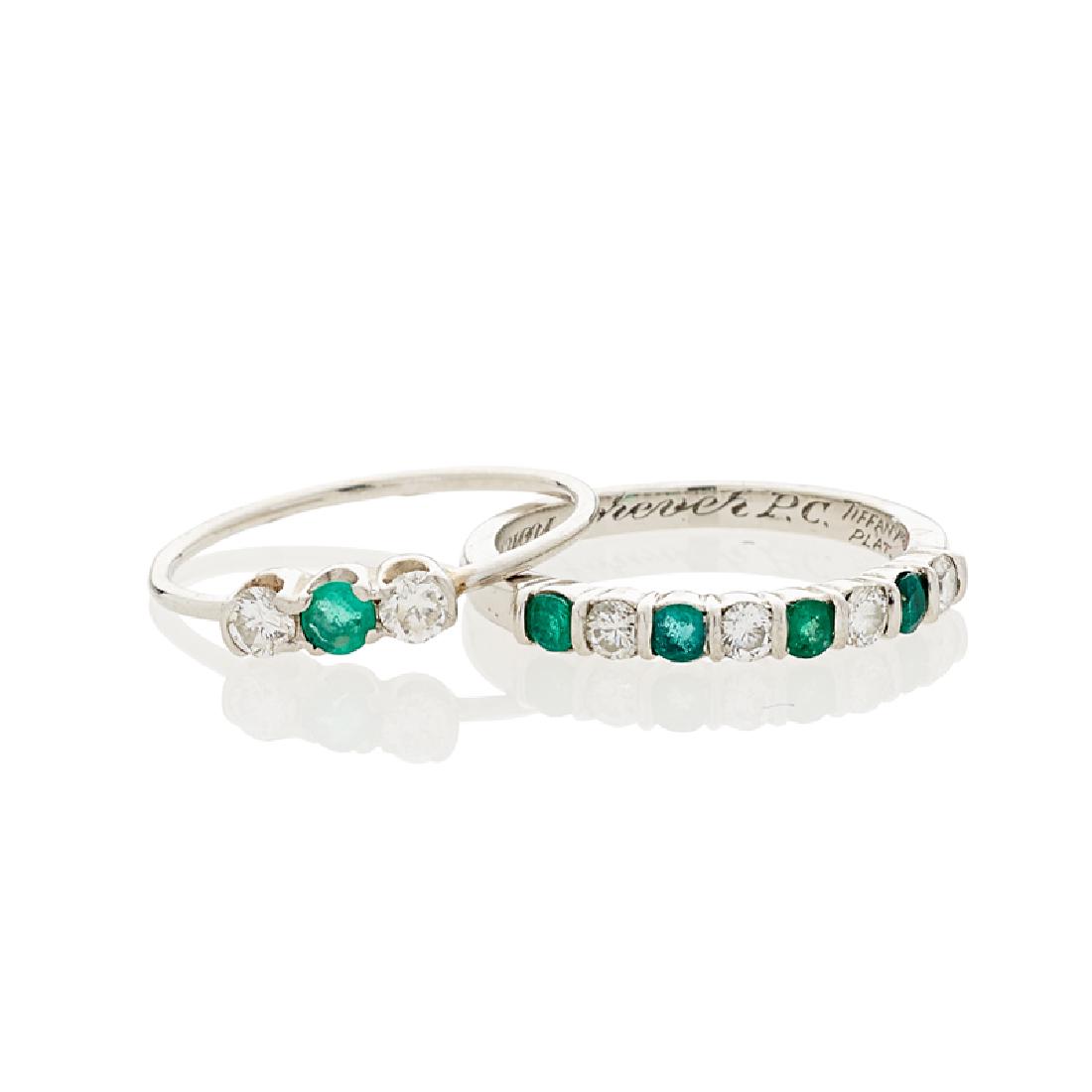 TIFFANY & CO. EMERALD, DIAMOND & PLATINUM BAND RINGS: The two bands with alternating round-faceted emeralds and RBC diamonds, approx. .28 ct. TW. throughout. Signed by the maker. Sizes 3 1/4, 3 1/2. 2.2 dwt.