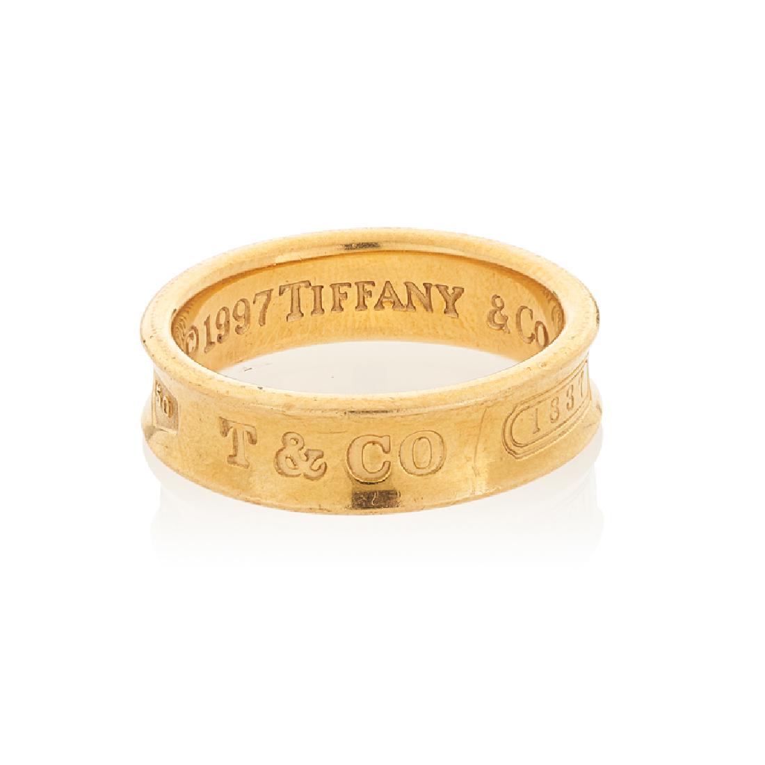 TIFFANY & CO. "TIFFANY 1837" YELLOW GOLD RING: 18k. Stamped by the maker. Size 8. 5.2 dwt.