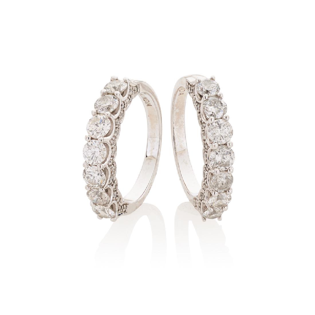 DIAMOND & WHITE GOLD STACKING RINGS: The two bands with prong-set RBC diamonds, above a scalloped diamond gallery, approx. 2.85 cts. TW. 14k. Size 6. 5.1 dwt.