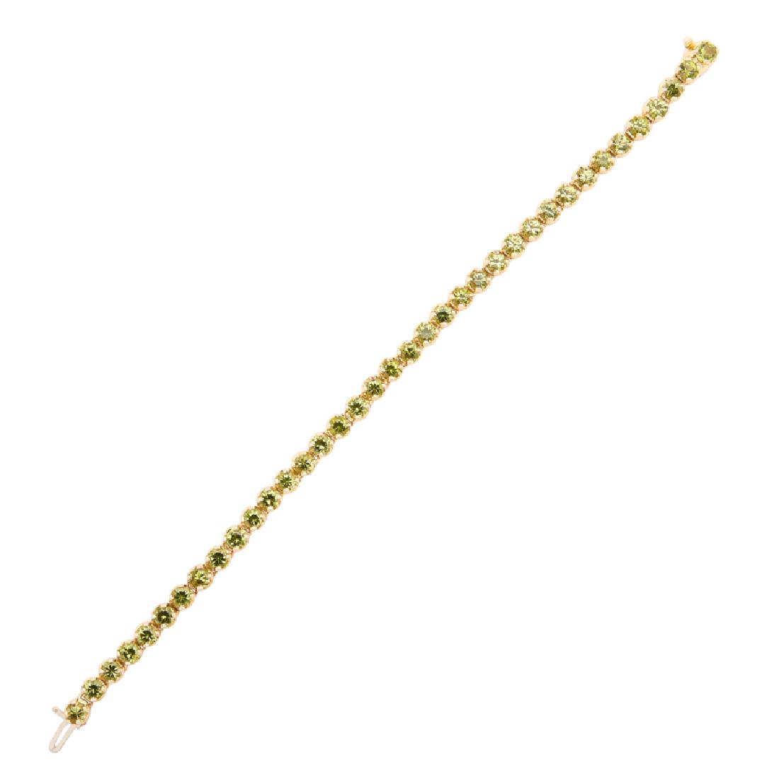PERIDOT & YELLOW GOLD LINE BRACELET: With round-faceted peridot. 14k. 7 1/4". 8.5 dwt.