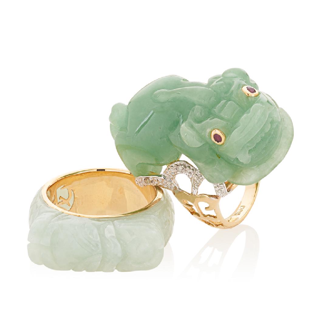 CARVED JADE & YELLOW GOLD RINGS: A chimera with garnet eyes, accented by RBC diamond ribbons, approx. .015 ct. TW.; A nephrite dragon band. 14k. Size 6. 11.8 dwt.