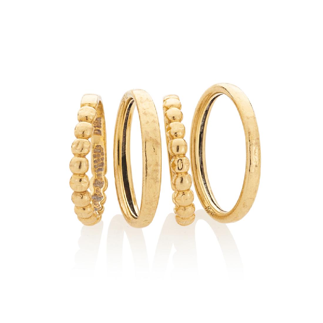 YELLOW GOLD STACKING RINGS: Comprising two pairs of hammered or beaded bands. 18k. Sizes 5 1/2- 6 1/4. 3.3 dwt.