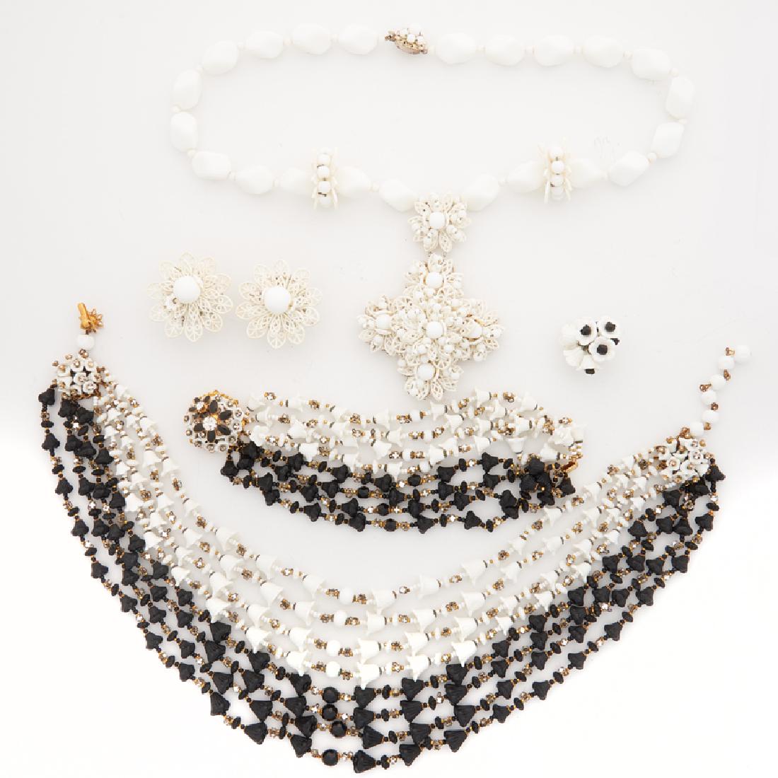 MIRIAM HASKELL FLORAL COSTUME JEWELRY: Comprising a bracelet and necklace suite designed as eight strands of black or white glass tulip beads alternating with prong-set rhinestones and joined by enameled floral clasps; An earring and penda