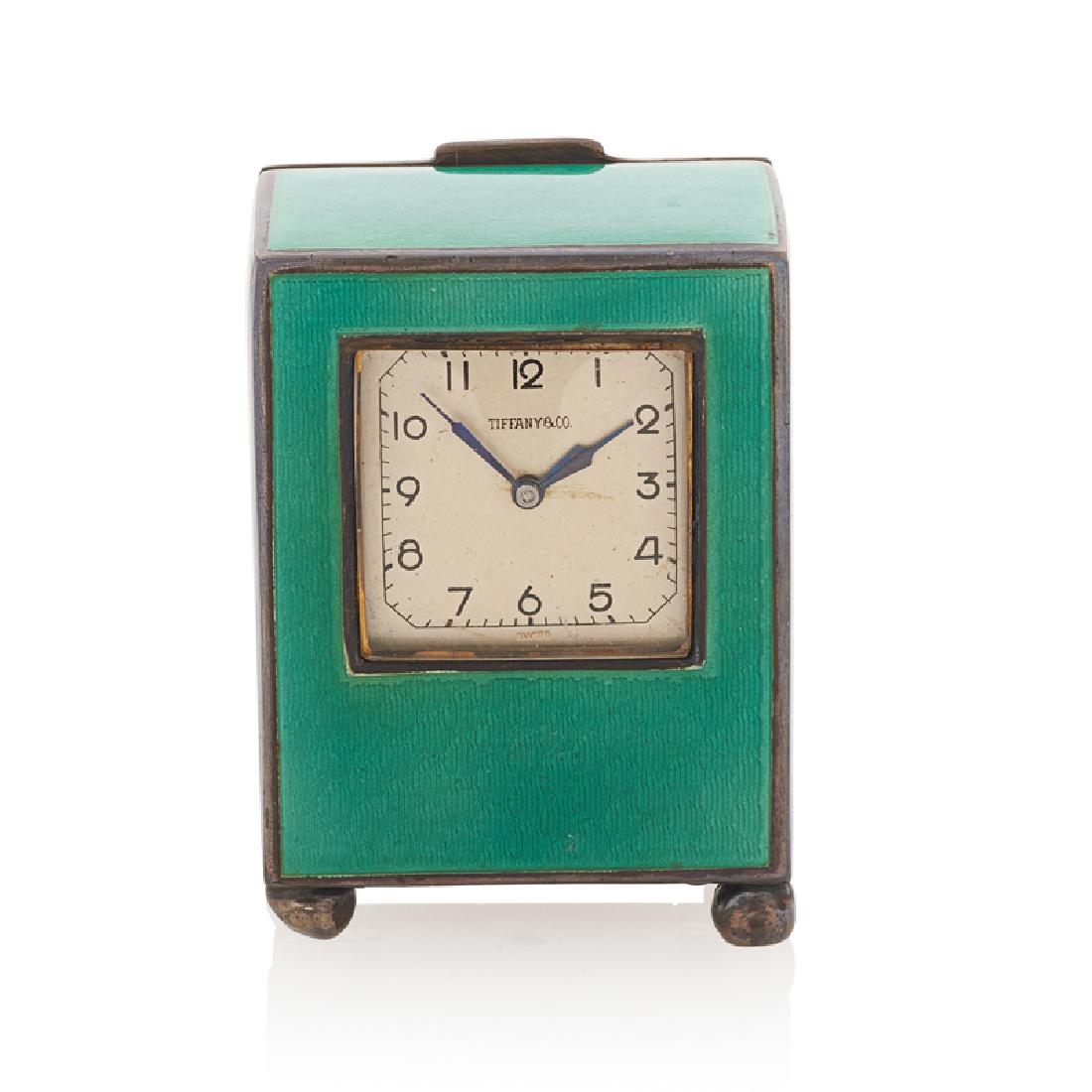 TIFFANY & CO. GUILLOCHE ENAMELED TRAVEL CLOCK: The green enameled silver clock with spherical feet, a cream dial with Arabic hours and dash minutes, and a Continental Lemania Inc. Swiss fifteen-jeweled movement #2266. 2 3/4" x 1" x 1 1/2". 137.0 g