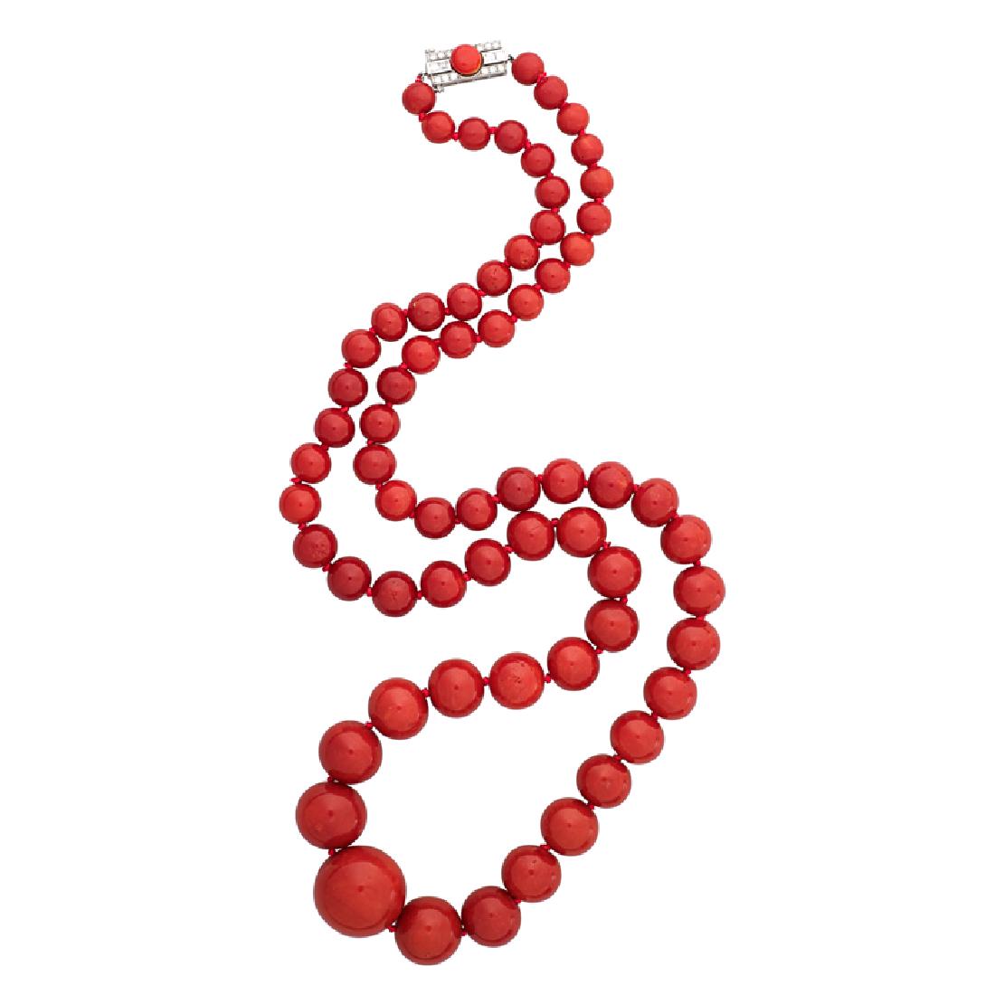 TIFFANY & CO. ART DECO CORAL & DIAMOND NECKLACE: A graduated strand of sixty-five dark red coral beads, 7.34 - 20.00 mm., joined by step and single-cut diamond or platinum clasp with coral button. Signed by the maker. Ca. 1925. 28". 111.5 gs.