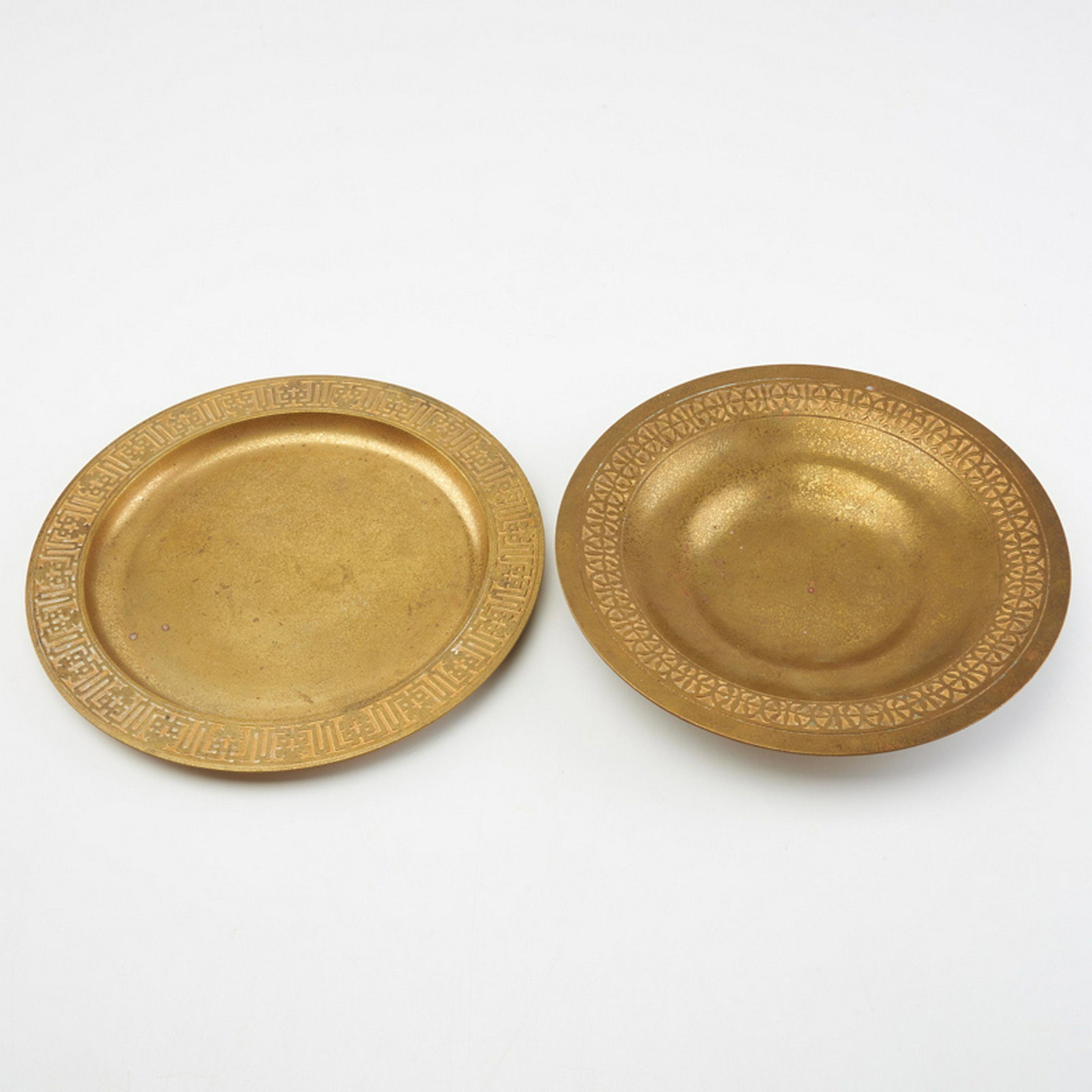 TIFFANY STUDIOS: Card tray and low bowl, with geometric borders, New York, 20th c. Gold doré bronze Stamp mark and numbered 1787/1707 card tray: 1/2" x 9" dia., low bowl: 1 3/8" x 8 7/8" dia.