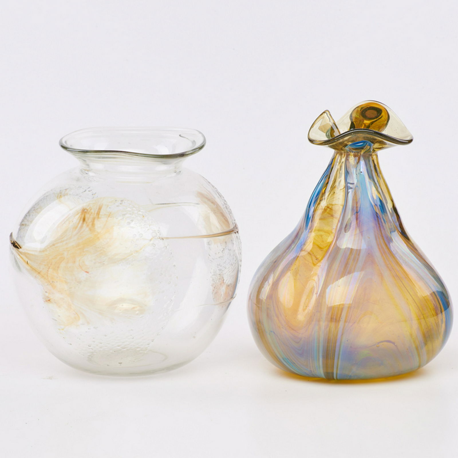 PETER BRAMHALL (American, 20th c.): Two art glass vessels: gourd-shaped and ovoid, USA, 1974/1975 Blown glass Each with etched signature and date Taller: 10" x 7 1/2" dia., shorter: 8 1/2" x 8 1/2" dia.