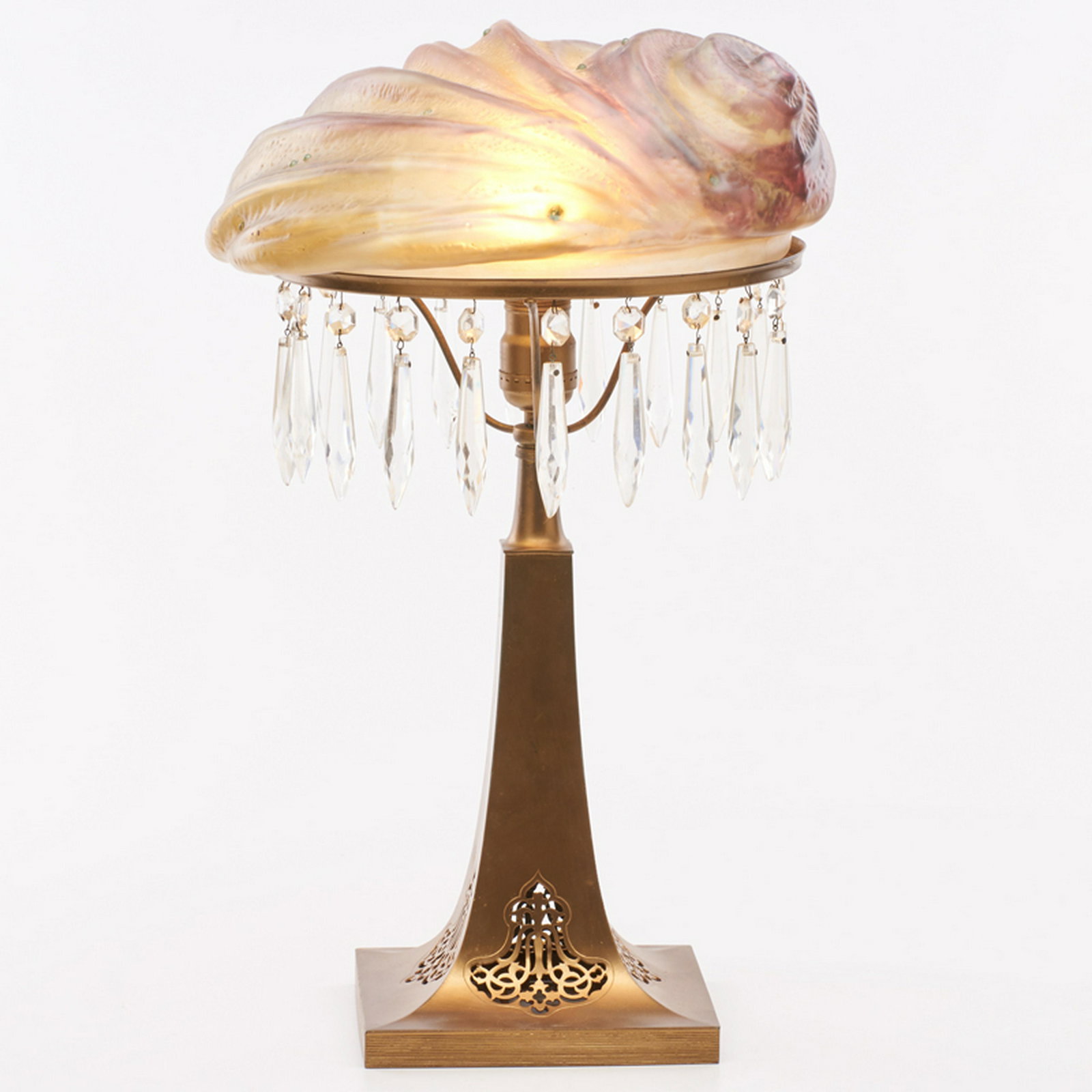 PAIRPOINT: Table lamp, Nautilus shade with cut crystal fringe, pierced base, Bedford, MA, 1910s-20s Molded, blown and patinated glass, gilt metal, single socket Base stamped PAIRPOINT MFG CO. P 3086 19" x 12 3/4
