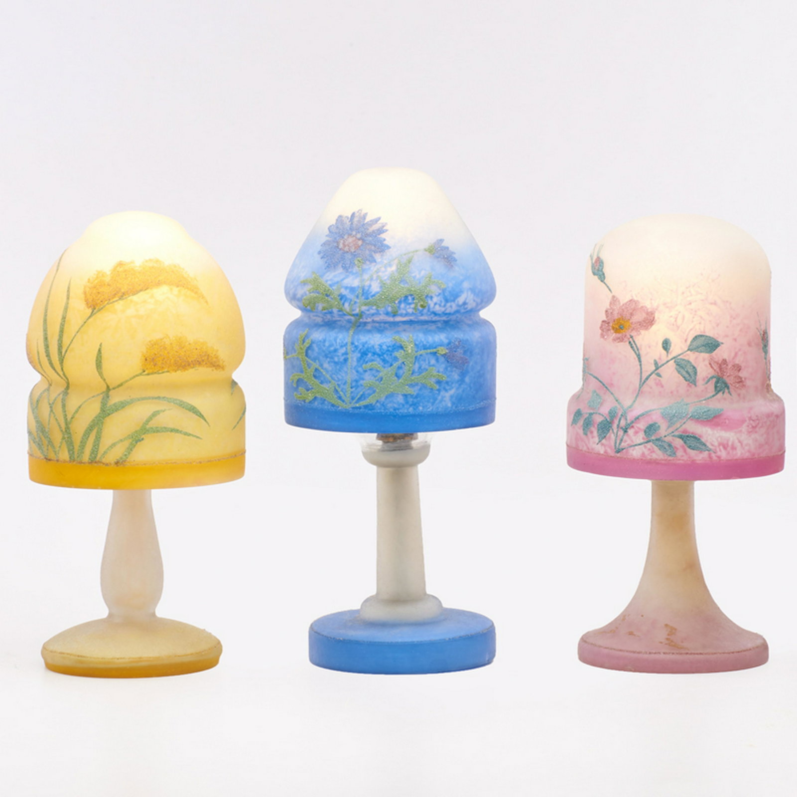 PAIRPOINT: Three reverse-painted fairy lamps, with floral coralene obverse decoration, Bedford, MA, first half of 20th c. Blown, acid-etched, and frosted glass, single sockets Shades each with The Pairpoint Corp