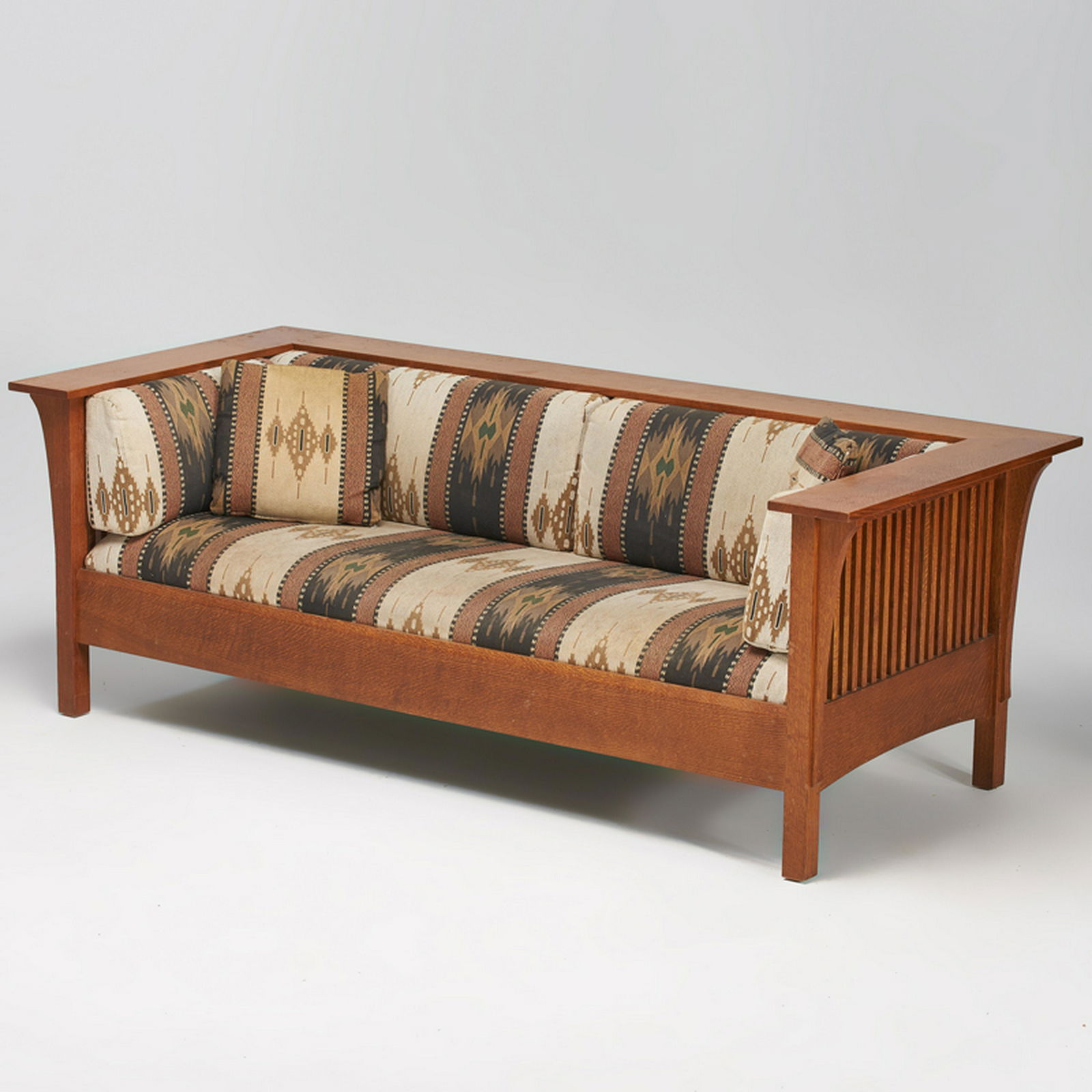 STICKLEY; E.J. AUDI: Contemporary spindled Prairie settle, Manlius, NY, 1990s Quartersawn oak, upholstery Metal tag, branded mark 29 1/2" x 84 1/2" x 37 1/2"
