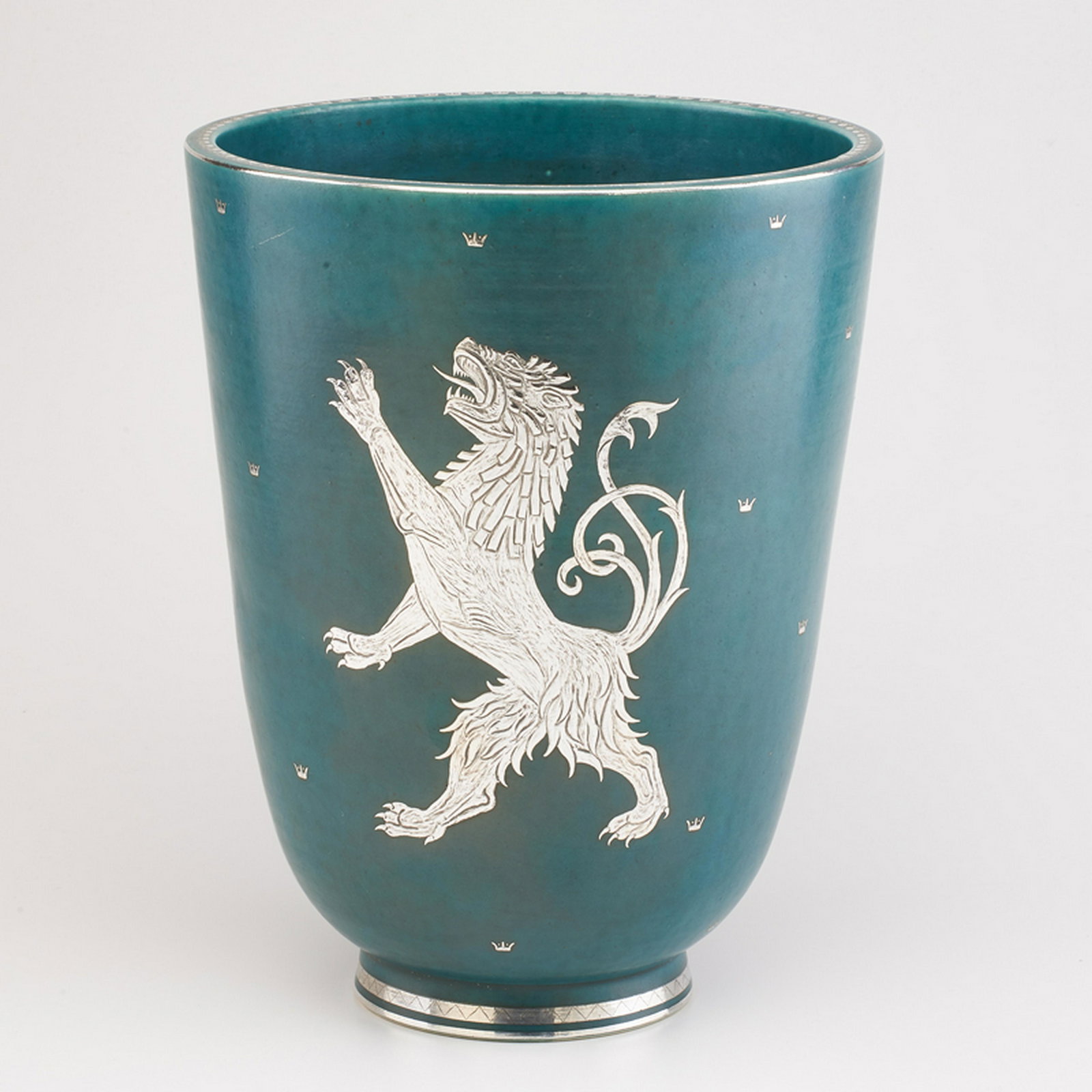 WILHELM KAGE (1889 - 1960); GUSTAVSBERG: Impressive Argenta flaring vase with central lion decoration, and overall crown detail, Sweden, 1934 Glazed earthenware, electroplated silver Marked HANDDREJAD/ARGENTA/978 IV/GUSTAVESBURG 11 1/2" x 9"
