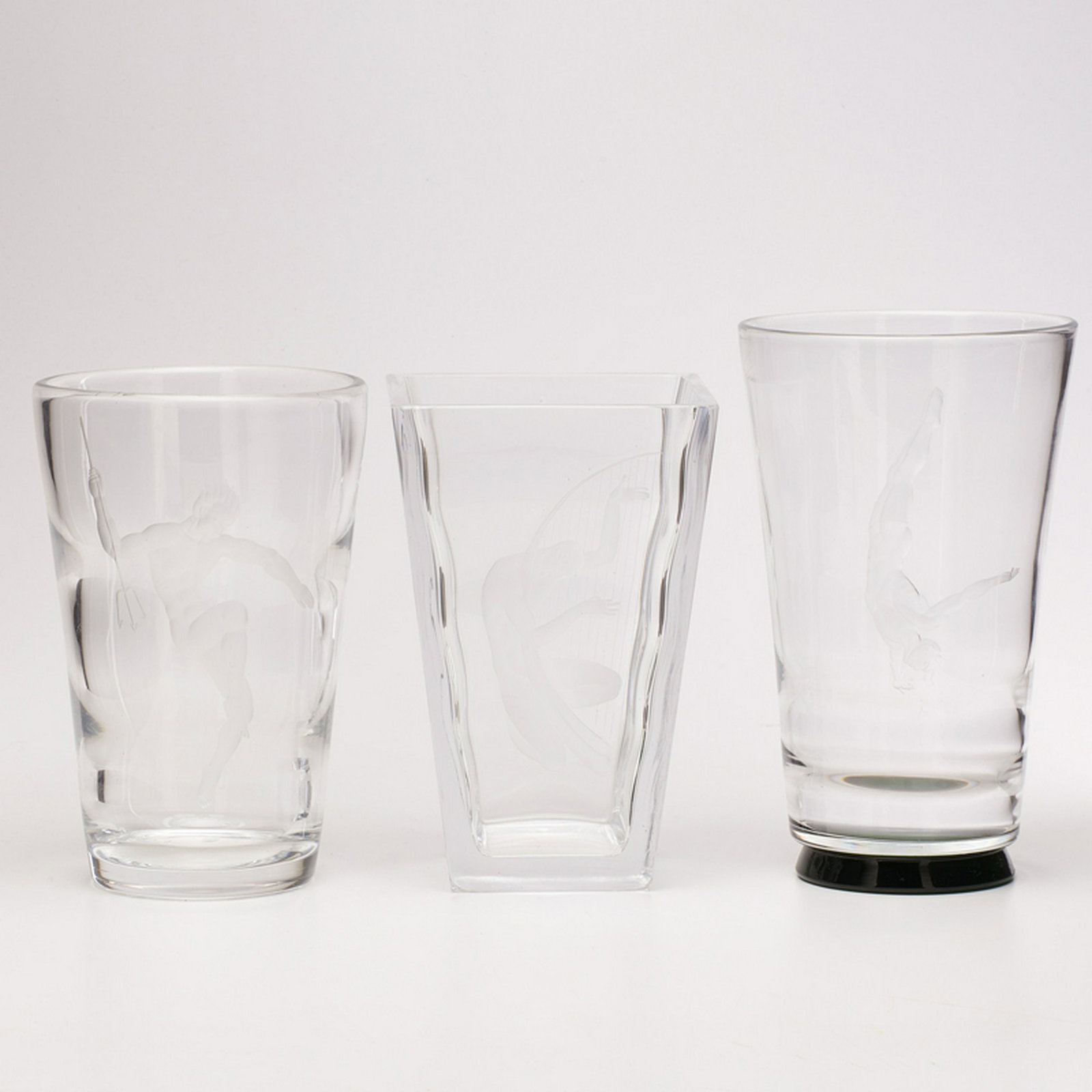VICKE LINDSTRAND (1904-1983); ORREFORS: Three vases: tapered square with nude Harpist, cylindrical with diver, and cylindrical with nude holding triton, Sweden, 20th c. Blow, clear and emerald, acid-etched glass Etched ORREFORS LINDSTRAND 1