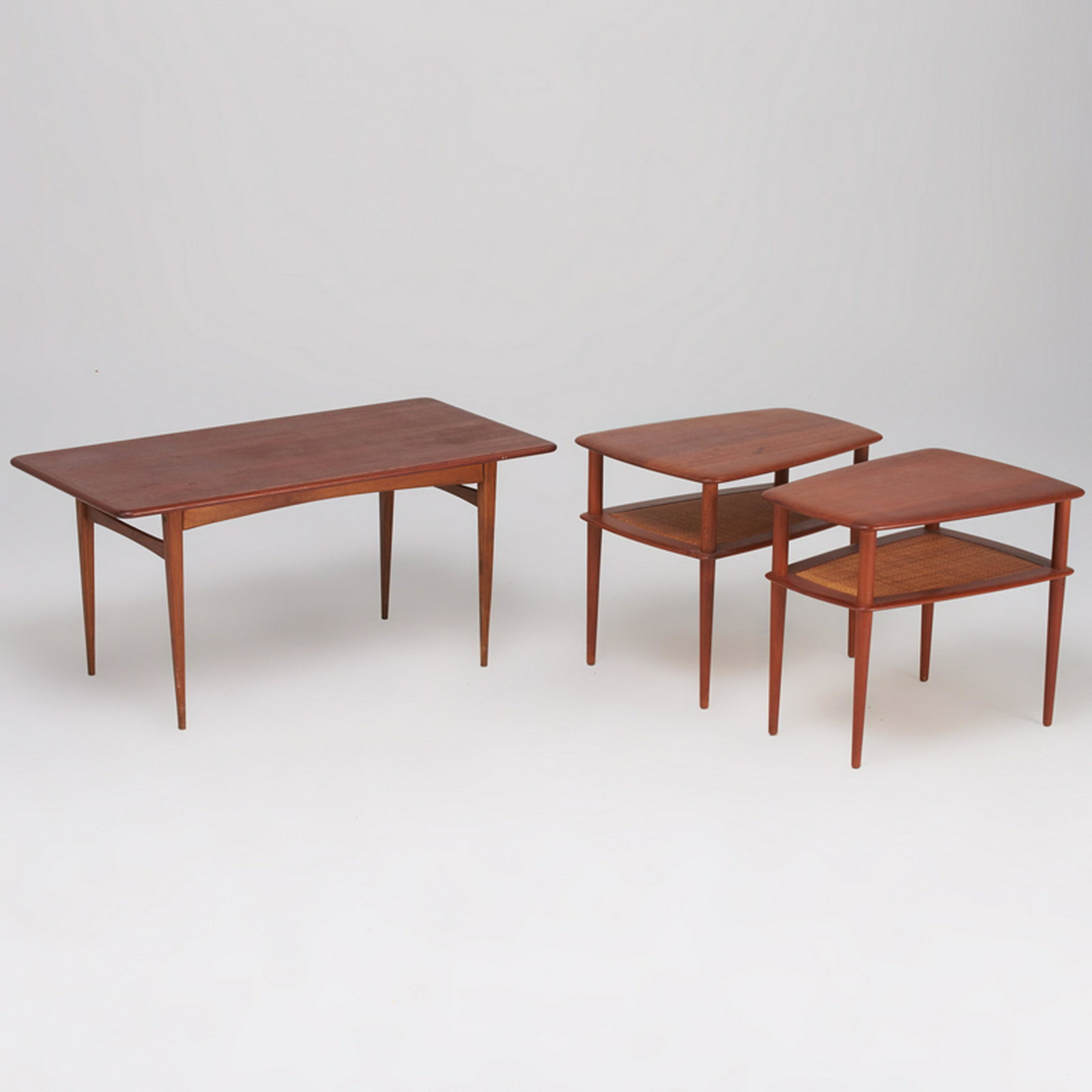 DANISH: Coffee table and pair of side tables, mid-20th c. Teak, wicker Side tables with France & Sons labels Coffee: 22" x 47 1/2" x 24", side tables: 23" x 20 1/2" x 28"