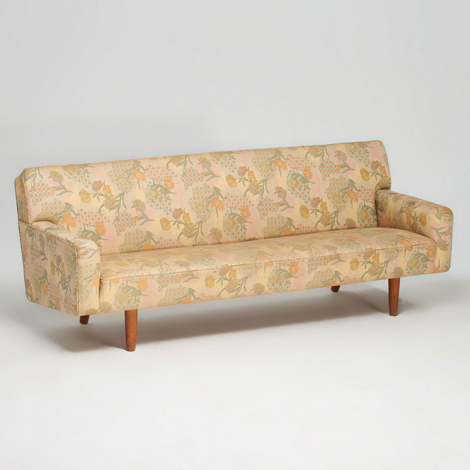 HANS WEGNER: Three seat sofa, Denmark, mid-20th c. Stained wood, upholstery Unmarked 31" x 80" x 30"