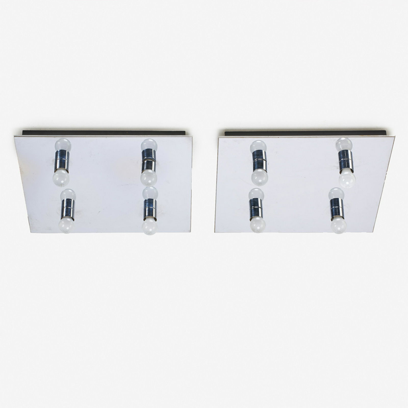 LIGHTOLIER: Pair of four-light ceiling fixtures/sconces, USA, 20th c. Chromed metal Manufacturer labels Each: 3 1/2" x 24" sq.