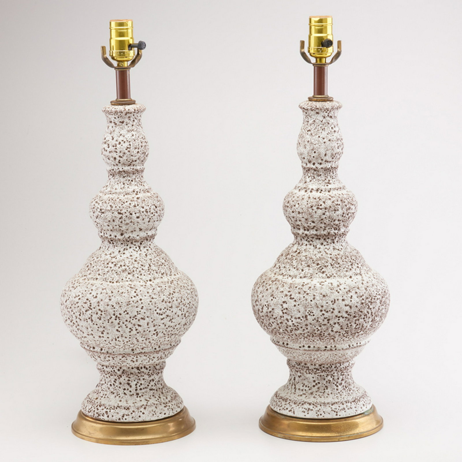 CHAPMAN LAMP CO.: Pair table lamps, in volcanic glaze, USA, 1991 Glazed ceramic, patinated metal Manufacturer labels 22 1/2" x 7 1/4" dia.