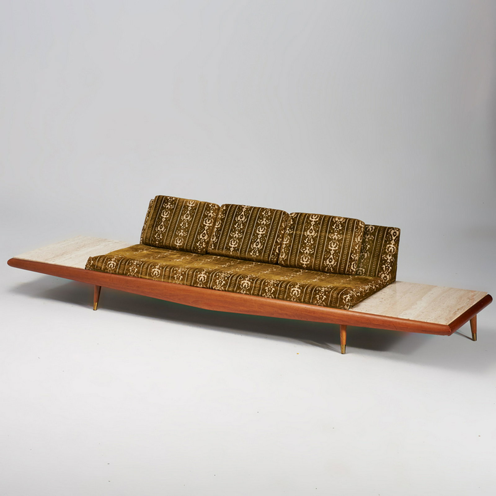 ADRIAN PEARSALL; CRAFT ASSOCIATES: Platform sofa, model no. 889-S, Wilkes Barre, PA, 1960s Walnut, travertine, wool velvet brocade upholstery, brass, steel Unmarked 24 1/2" x 126" x 33"