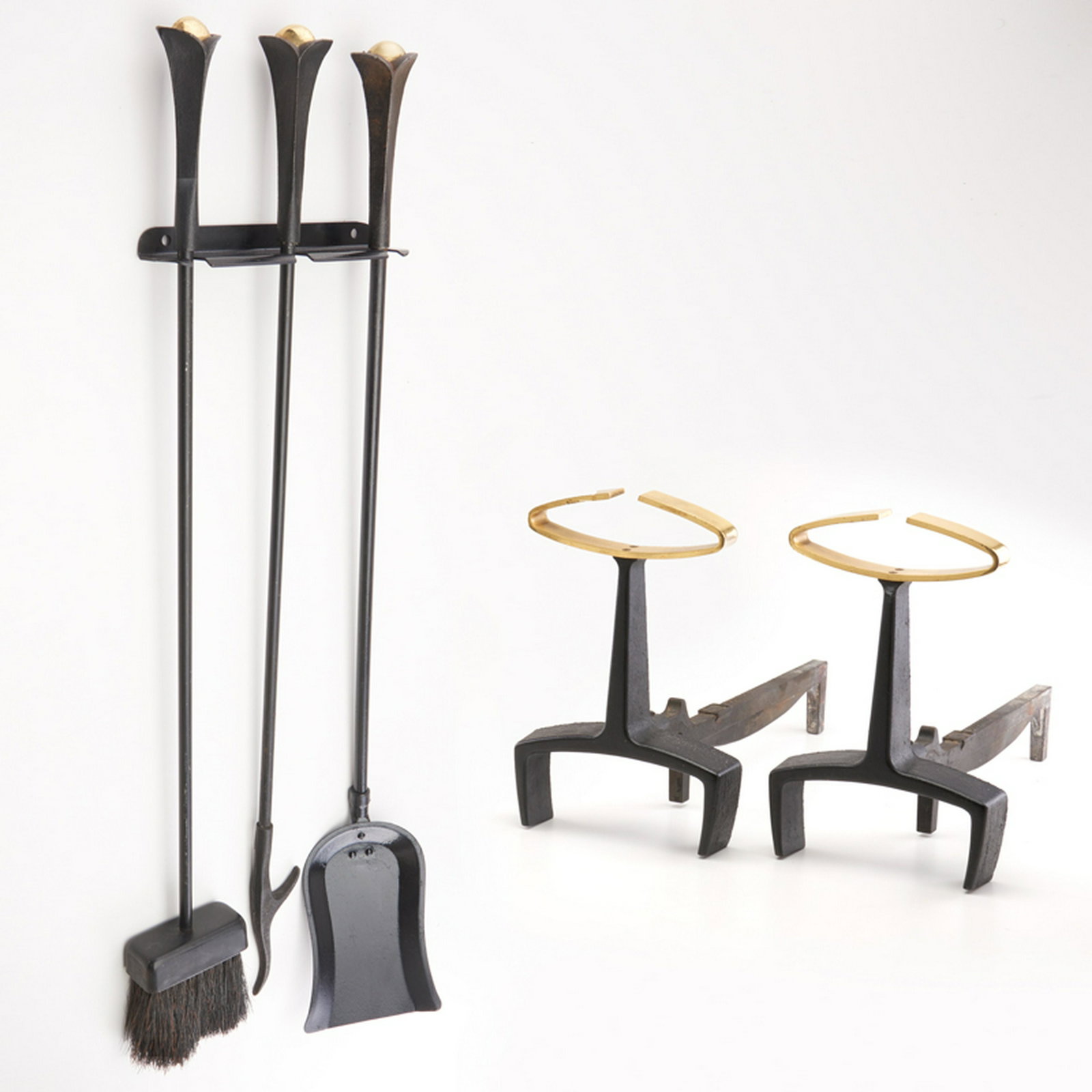 DONALD DESKEY; BENNETT: Six-piece fireplace set: pair of andirons, poker, shovel and brush on wall-mounted stand, USA, ca. 1920s Brass, black-enameled cast-iron and metal Firedogs with raised marks Andirons: 13" x 8 1/2" x 1