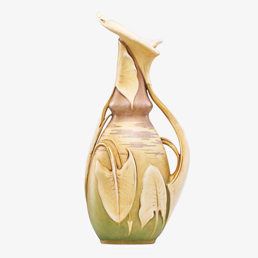 RIESSNER, STELLMACHER & KESSEL Calla lily pitcher: RIESSNER, STELLMACHER & KESSEL Amphora Calla lily pitcher, Turn-Teplitz, Bohemia, ca. 1900 Red RSTK stamp, impressed AMPHORA 495/41, signed 8165 14" x 6 1/4" x 5" Provenance: Rago Auctions, Early 20th