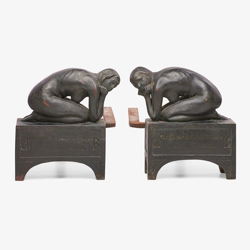 PAIR OF FIGURAL ANDIRONS: Cast iron firedogs, inscribed with the lines from a Medieval students drinking song 9 3/4" x 9 1/2" x 19 1/2"