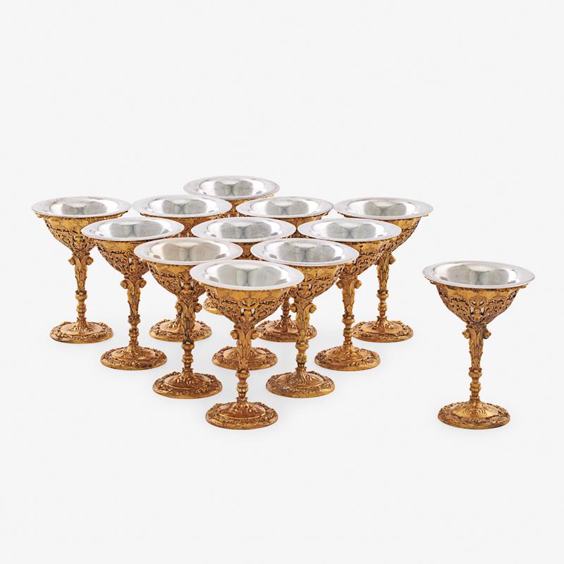 TIFFANY & CO. STERLING & GILT SILVER GOBLETS: Twelve: In the Renaissance Revival style, cast and chased with strap work, fruit festoons and detachable sterling liners, USA, 1902-07 Marked 5 1/2", 111.2 ozt Provenance: L'Antiquaire, Palm Beach, 3 