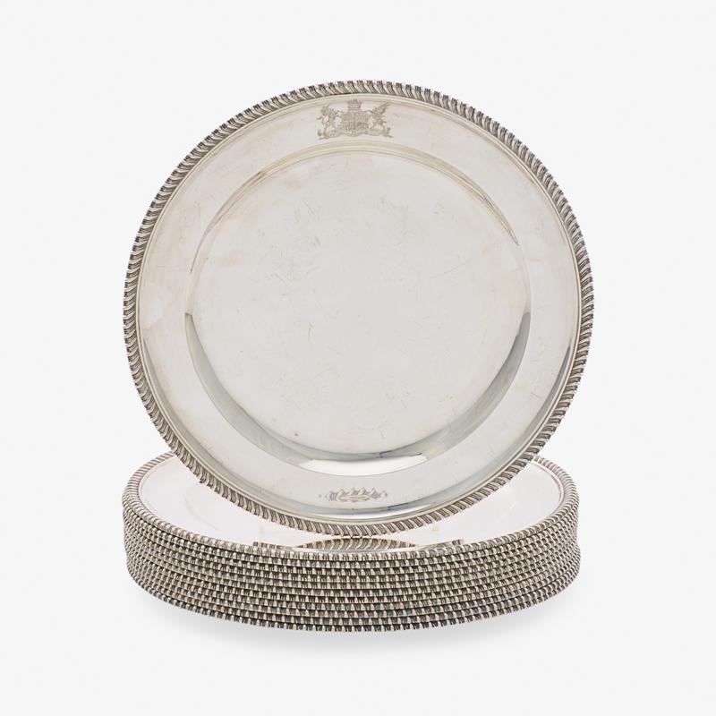 GEORGE V SILVER DINNER PLATES: Twelve: With gadrooned border, rim engraved with coat of arms beneath a Viscount's coronet, by Sebastian Garrard, London, 1928 Marked "Made by Garrard of London for James Robinson" 11" dia, 309 ozt