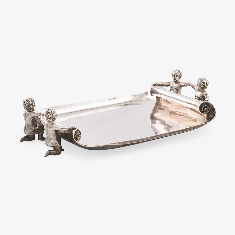 VICTORIAN SILVER TRAY: Shaped rectangular tray with kneeling putti handles by Daniel and Charles Houle, London, England, 1860 Marked 4 5/8" x 20 3/4" x 13 1/4", 100.1 ozt Provenance: L'Antiquaire, Palm Beach, 3 January 1989