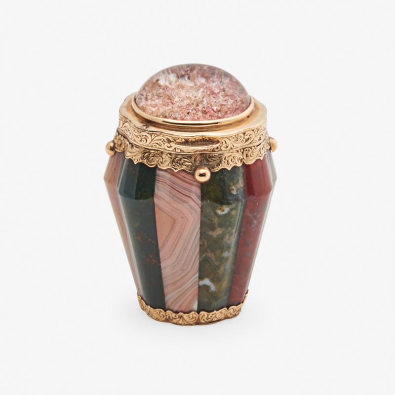 VICTORIAN SCOTTISH HARDSTONE VINAIGRETTE: Silver gilt mounted, of lobed barrel form with varied hardstones, the hinged cover inset with quartz, with fitted grille, and fitted leather case, mid-19th c. 2 1/4"