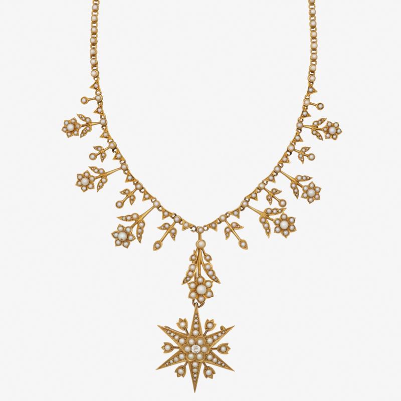 EDWARDIAN SEED PEARL & YELLOW GOLD NECKLACE: A floral starburst pendant brooch with central OEC diamond, approx. .20 ct., suspends from stemmed flower links on chain. Ca. 1905. 14k. 15", 2 1/2". 22.0 dwt.
