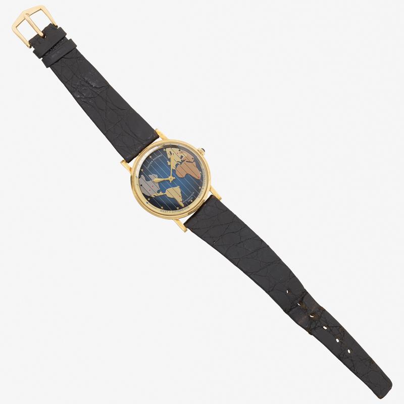 LUCIEN PICCARD "WORLD MAP" GOLD WRISTWATCH: The round blue dial with tri-tone world time zone calendar, autowind movement #K125614, 17 jewels, case #49881. 33.0 mm, leather strap 6 1/2" - 8". 14k.