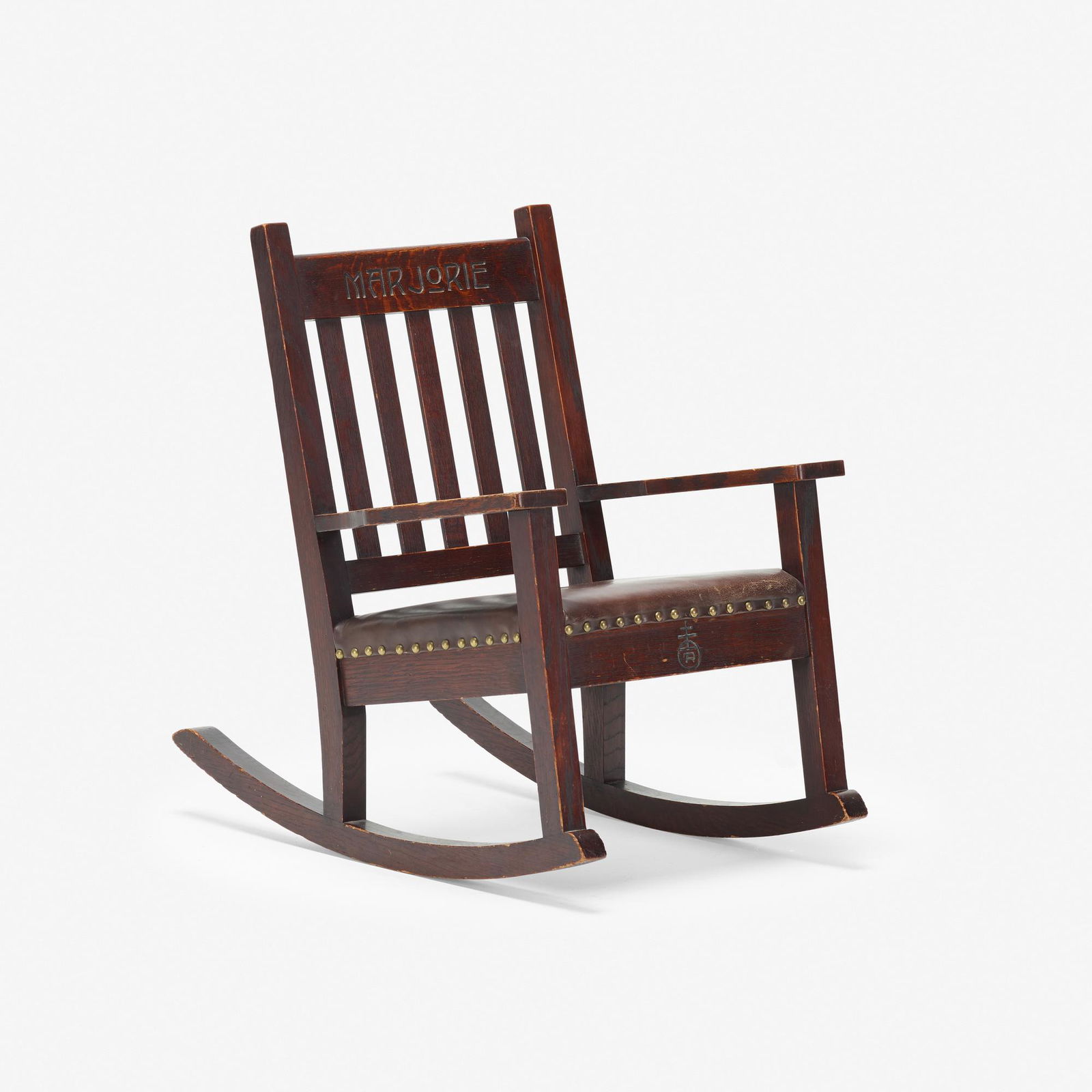 Roycroft, rare child's rocker: Roycroft rare child's rocker USA, c. 1906oak, leather, brass28 h × 19.25 w × 28.5 d in (71 × 49 × 72 cm) Carved orb and cross mark and signature to front 'Marjorie'.