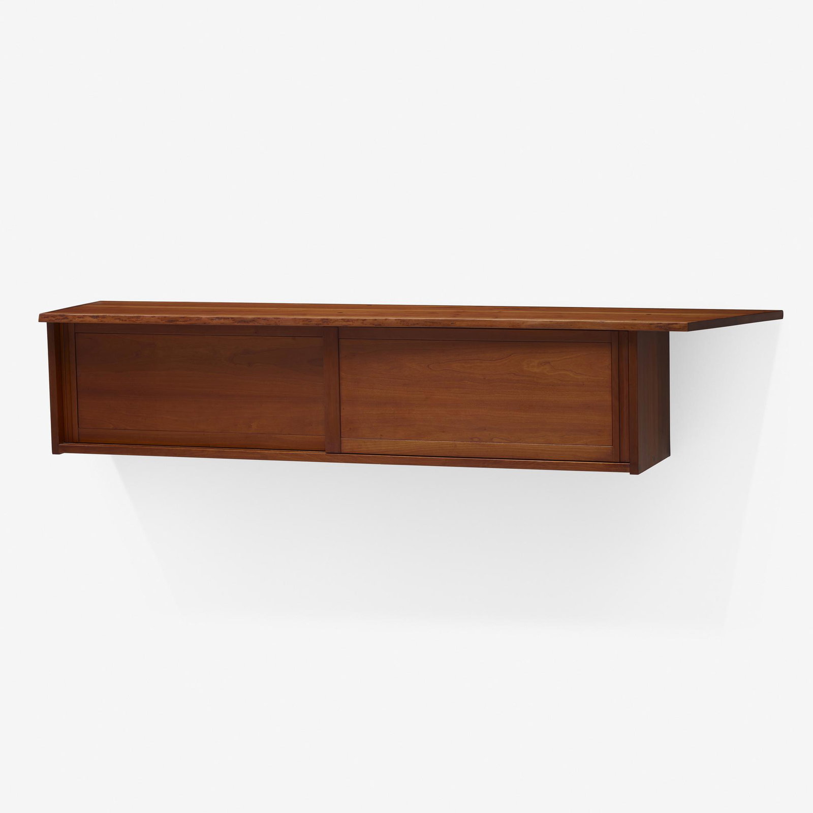 George Nakashima, Hanging Wall Cabinet: George Nakashima Hanging Wall Cabinet Nakashima Studio USA, 1960 cherry 14.25 h × 71.25 w × 14 d in (36 × 181 × 36 cm) Cabinet features two overhangs, one with a natura